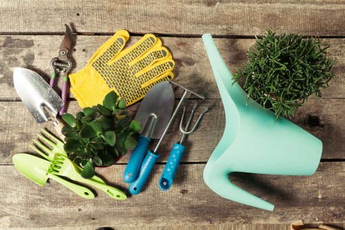 Team of gardeners at work in a Twickenham garden with safety gear