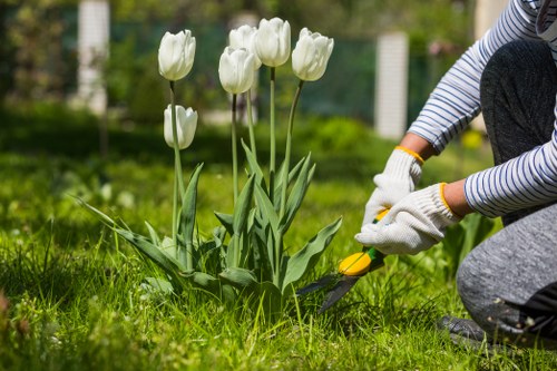 Team of gardeners working in a Twickenham garden, symbolising anti-slavery commitment